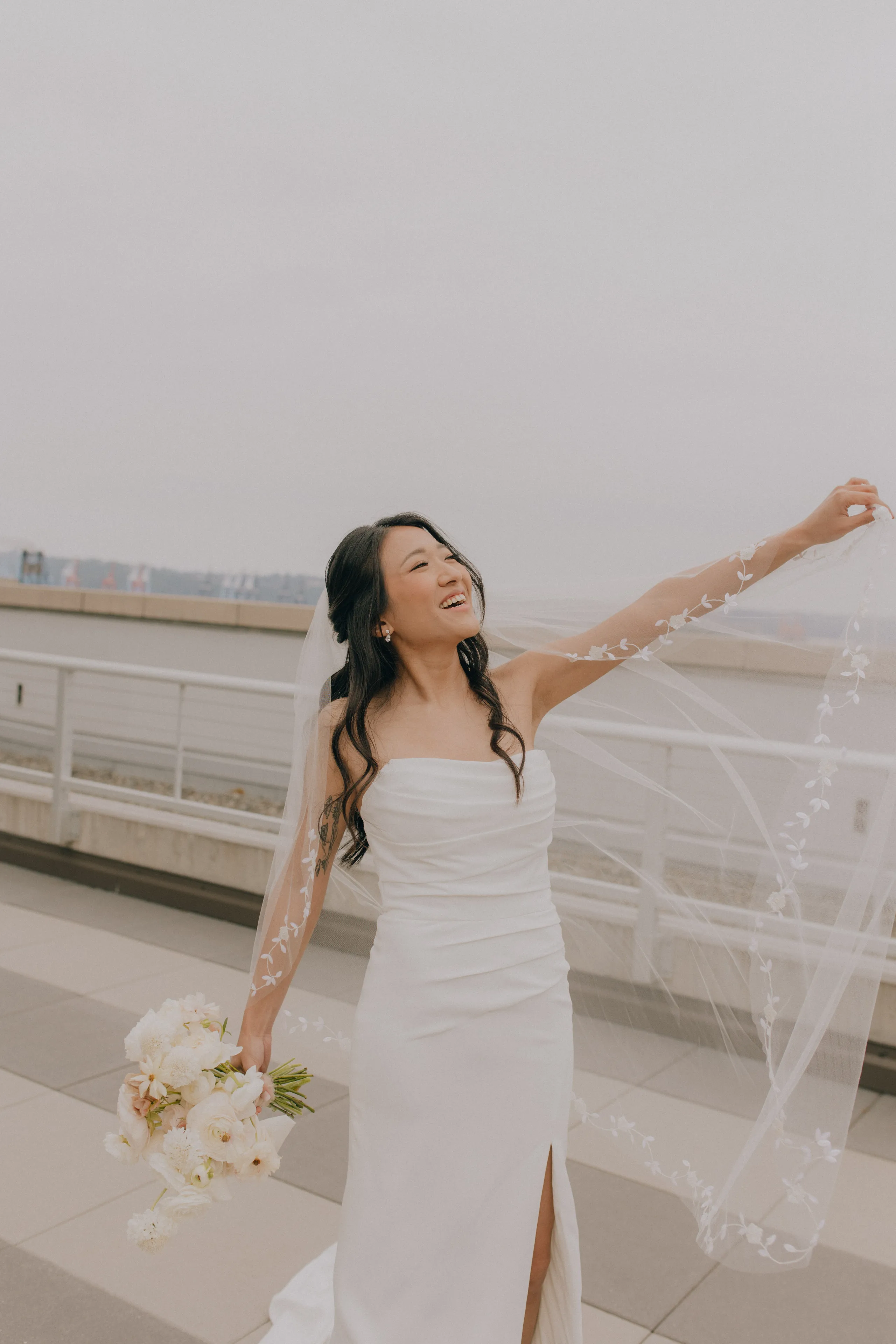 Bride smiling with arm out